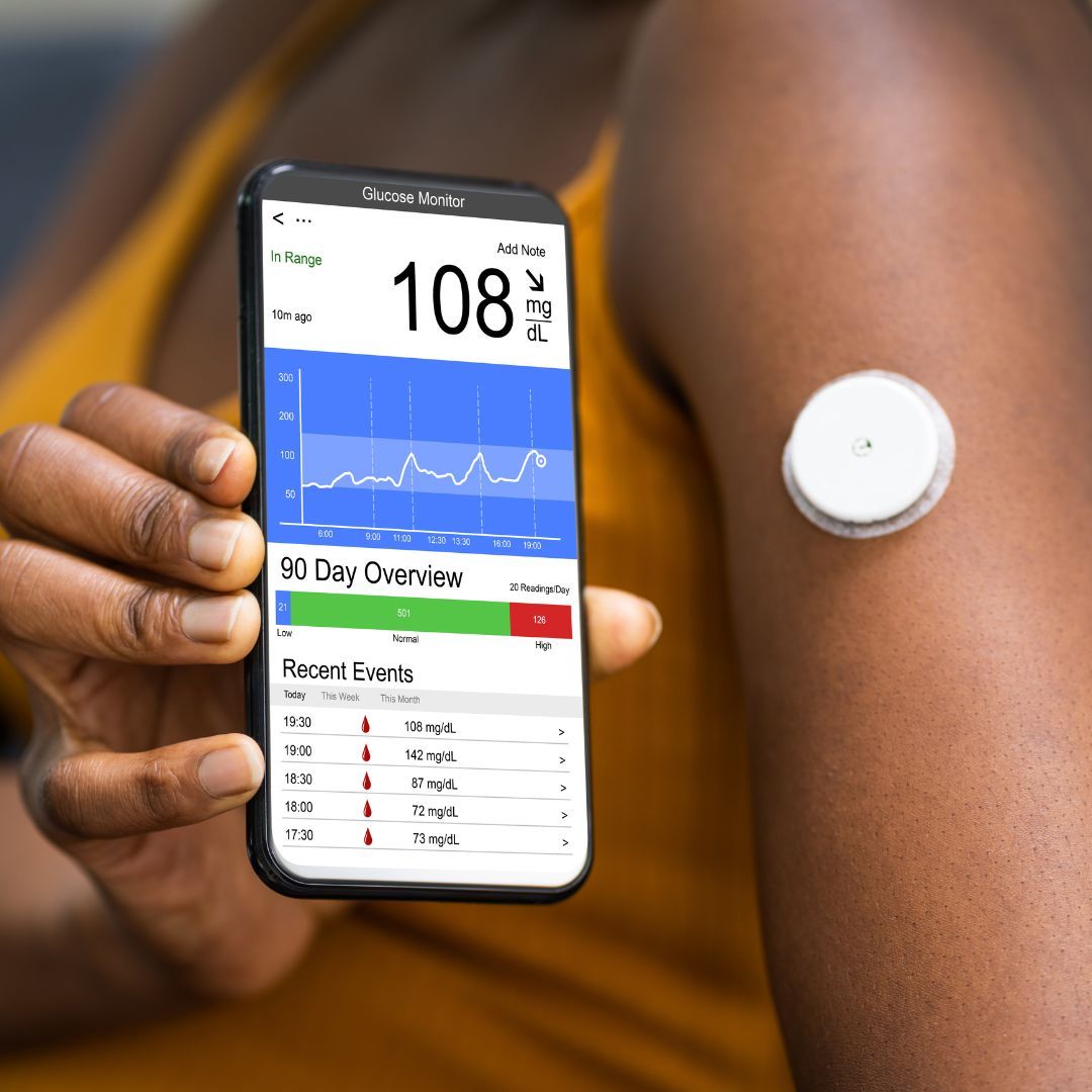 a person showing us their continuous glucose monitor and their phone reading