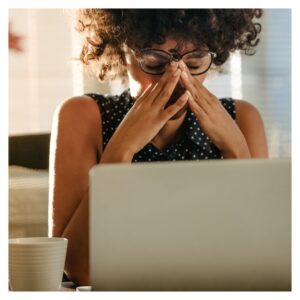a women looking at her computer, stressed out