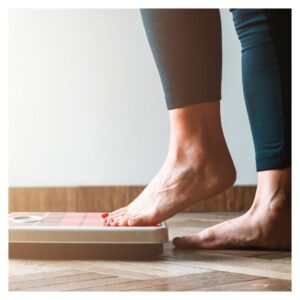 a women stepping on a scale