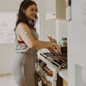 A woman wearing a glucose sensor