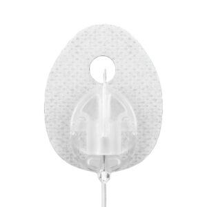 Close-up of a Tandem AutoSoft 30 infusion set, showing the oval-shaped adhesive patch and the clear plastic cannula housing with a central hole.