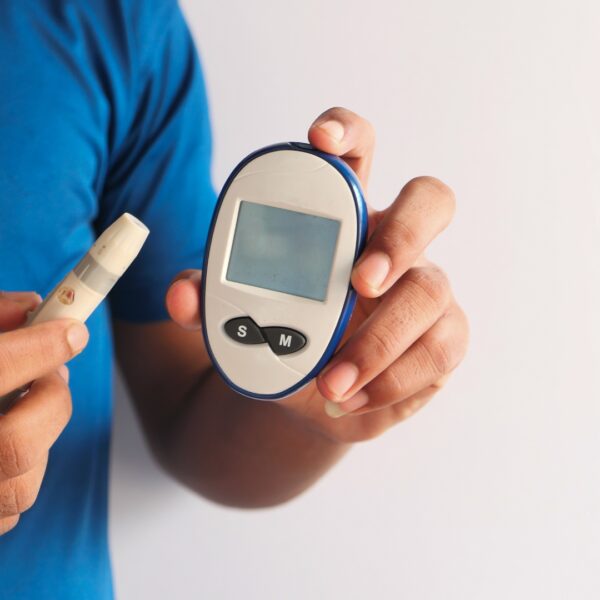Man holding a glucose monitor