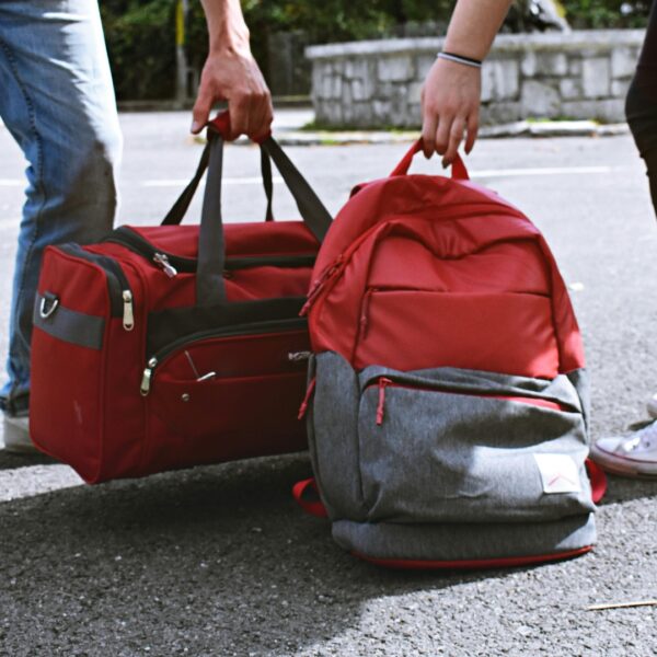Hands picking up carry-on bags