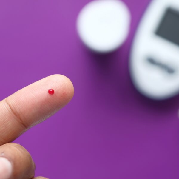 Small speck of blood next to a glucose monitor